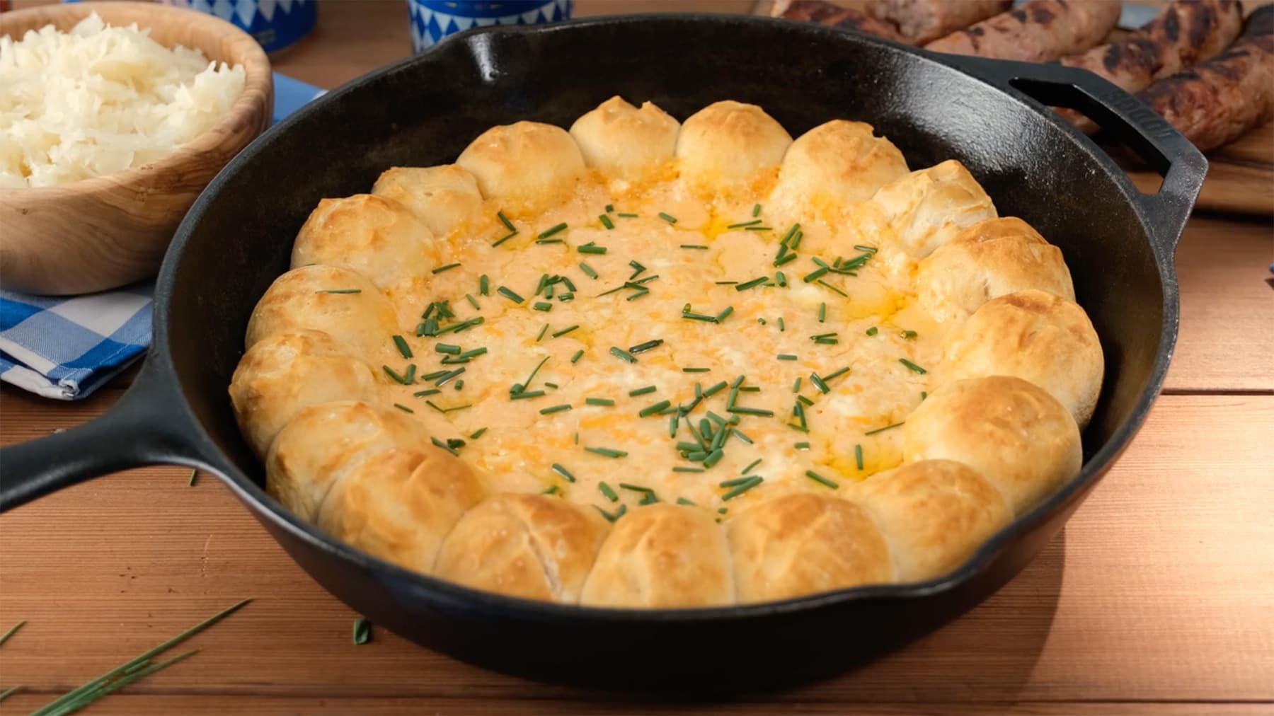 A cast-iron skillet filled with biscuits and beer cheese