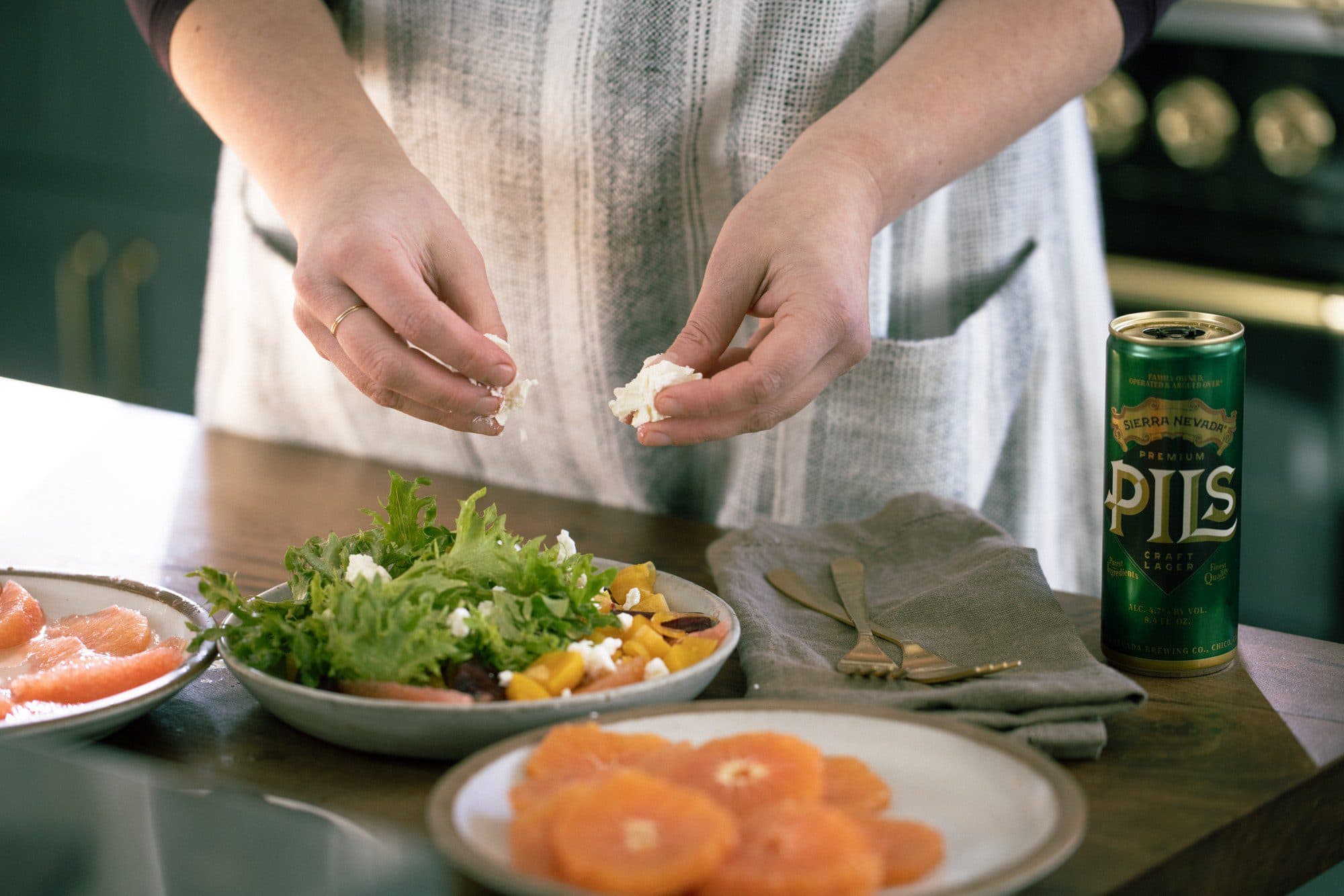 Sierra Nevada PILS on a table next to beet salad.
